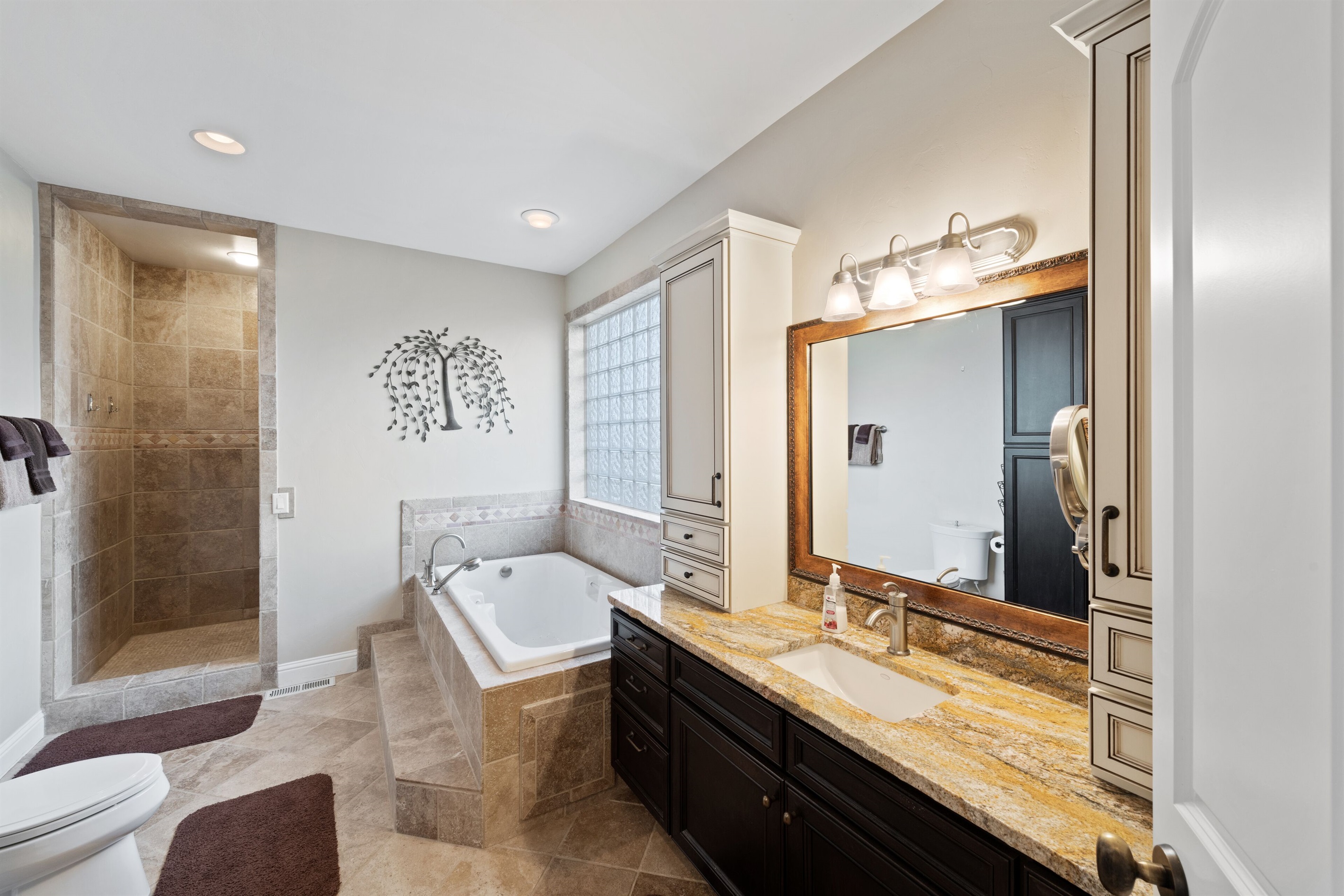 (bdrm1) master bath with vanity, jetted tub and tiled glass privacy window