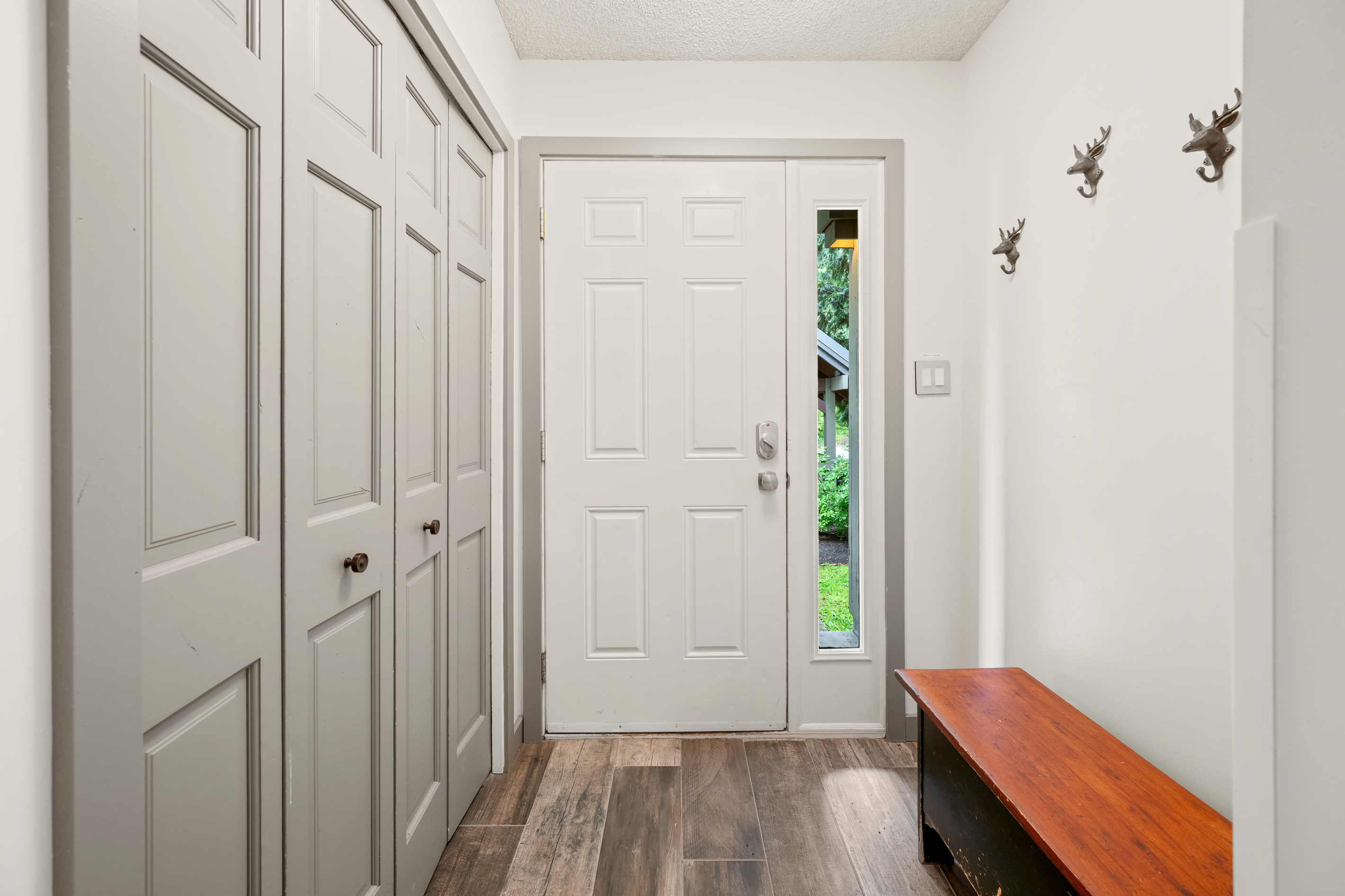 Private entry foyer with a closet for coats, boots and ski gear.