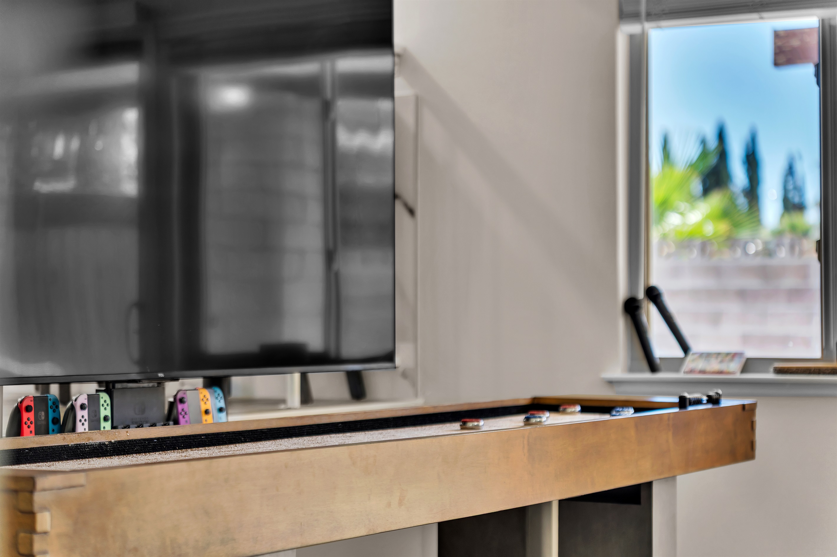 Living room 2 with 86 inch tv, shuffleboard, Nintendo switch, karaoke and bar sink