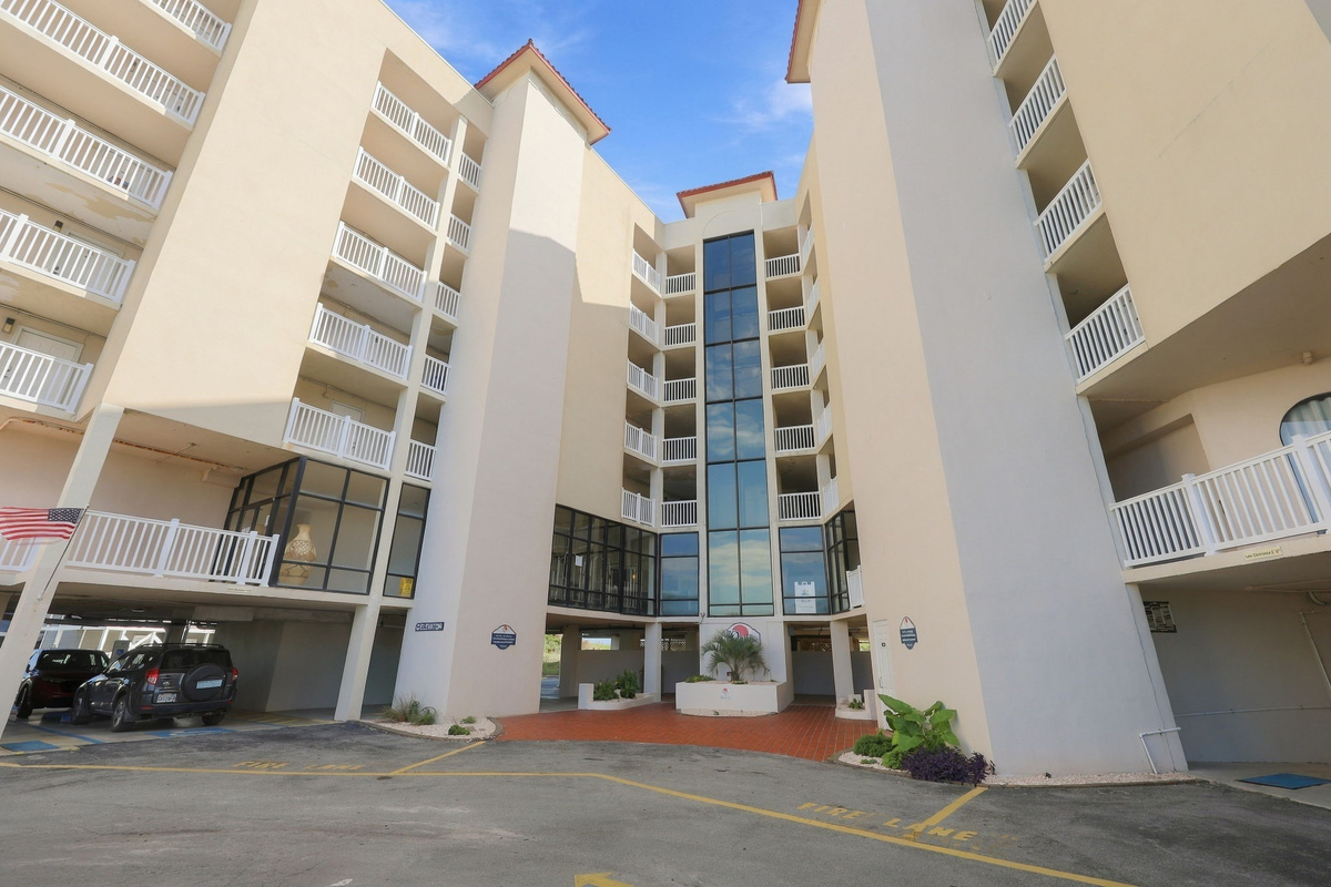 Exterior view of the resort building and convenient covered parking area.