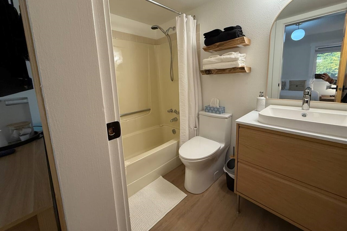 Bathroom Details: Includes a new comfort-height toilet and a clean shower/tub combination, with thoughtful storage solutions provided.