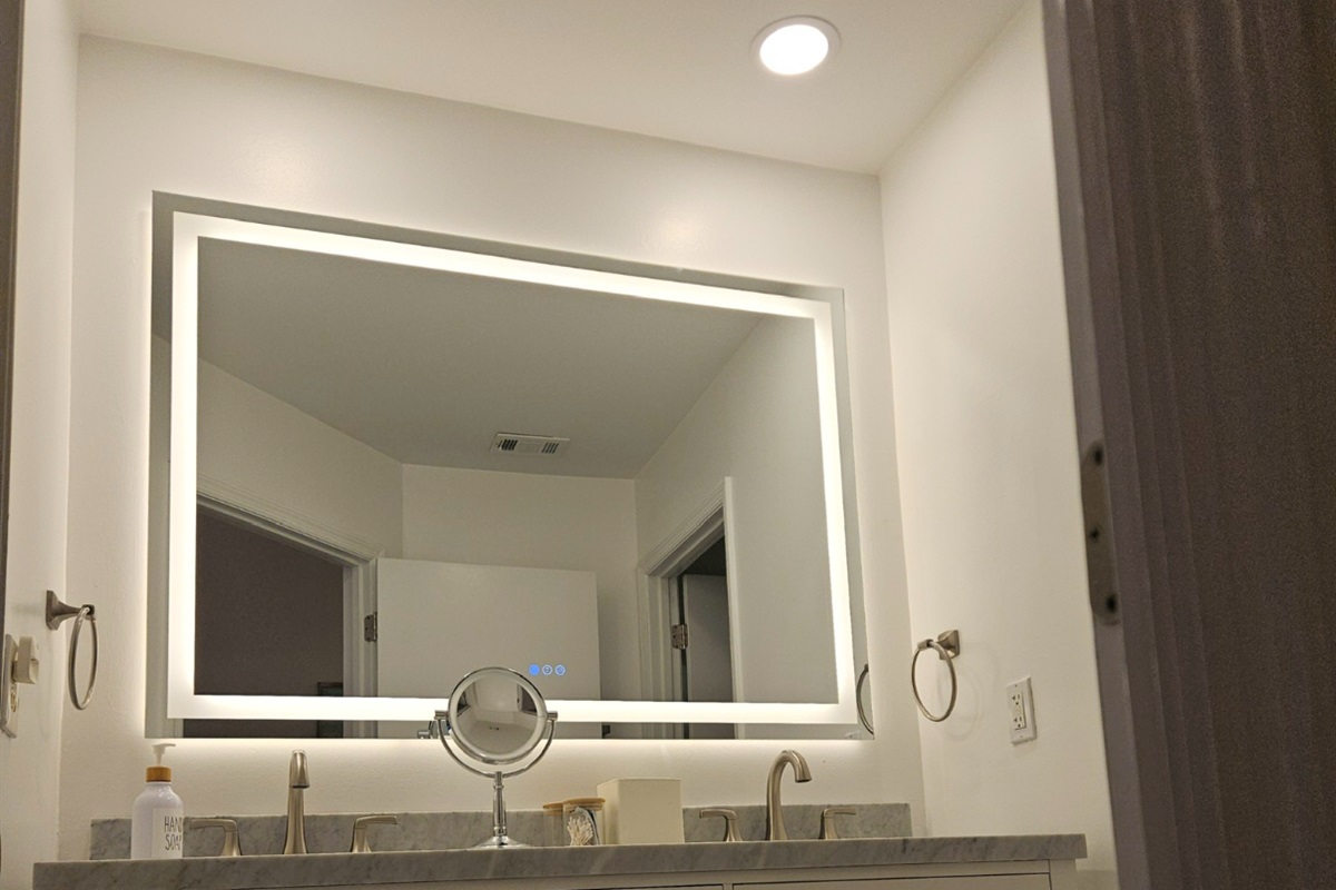 New master bathroom marble vanity w/ LED mirror and recessed lights.