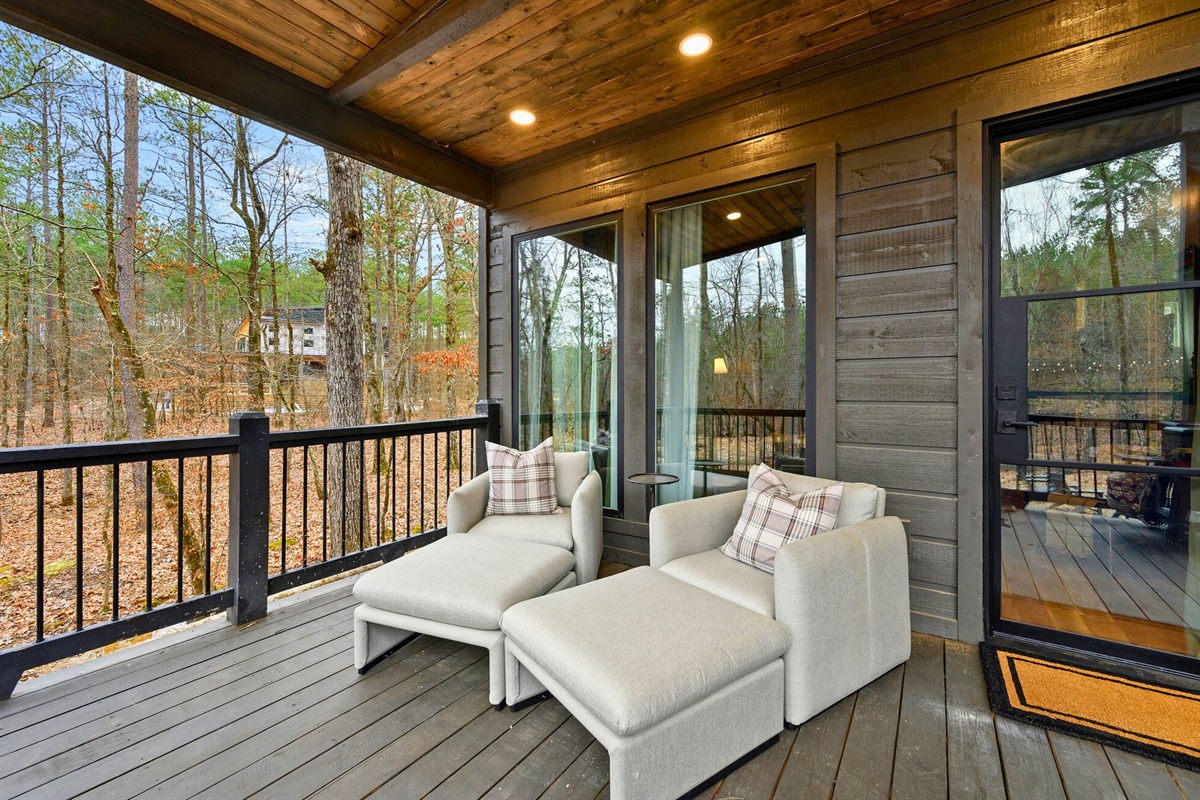 Comfy loungers sit on the screened-in porch, offering a quiet spot to read, nap, or sip your morning coffee.