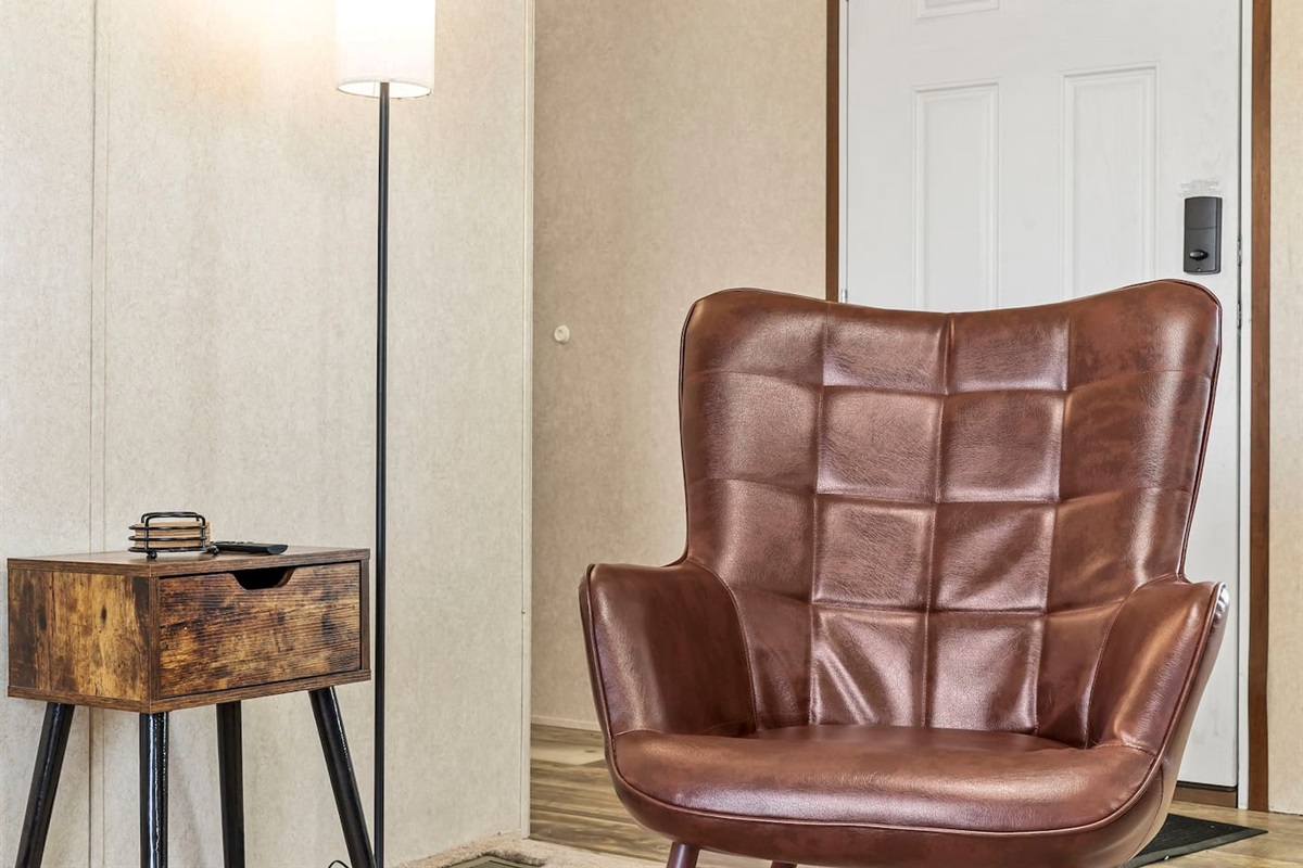 Stylish accent chair and reading nook near the entry—ideal for unwinding after a long day.