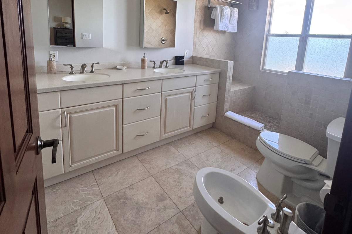 Bright bathroom vanity with plenty of storage, fresh towels, and a large mirror for easy getting ready.