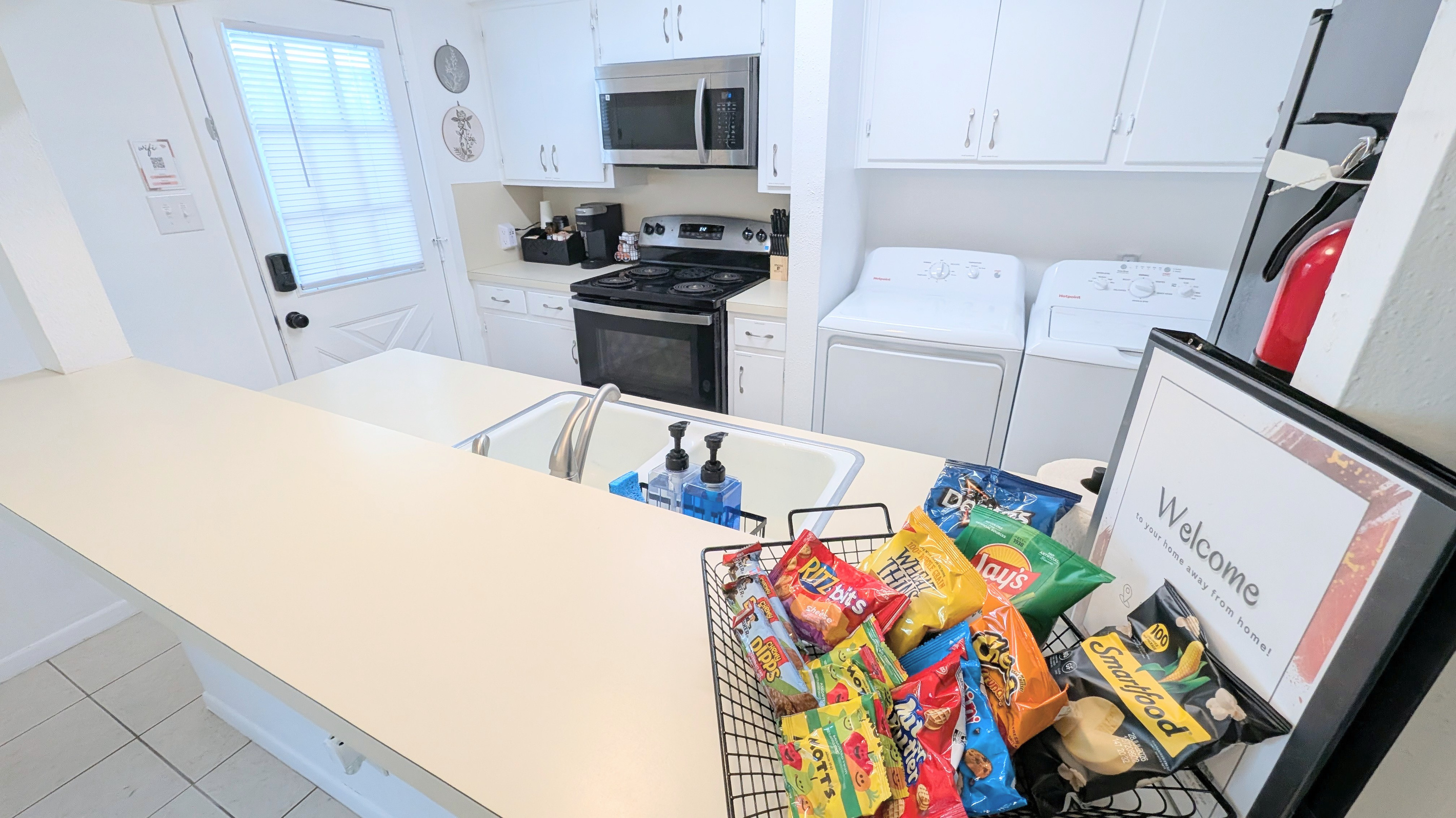 Kitchen is fully stocked and has direct access to the backyard courtyard, patio, and carport. 