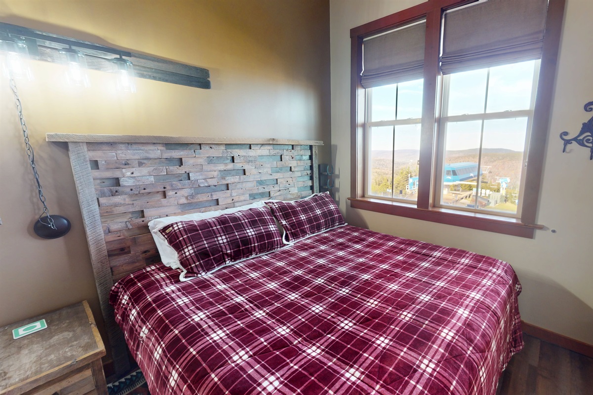 Cozy alpine-style bedroom featuring handcrafted wood headboards and soft linens.