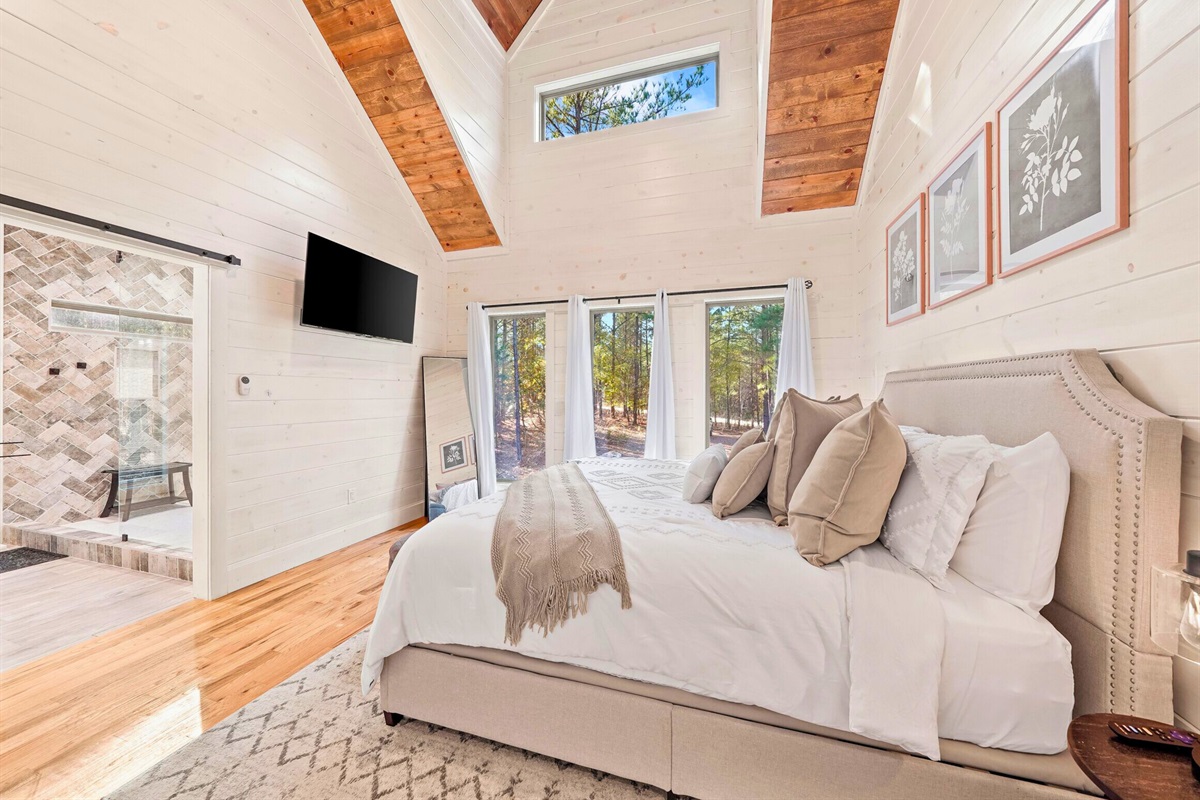 Bedroom with bright windows and soft linens.