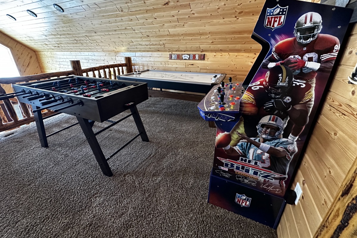 Upstairs game area w/ air hockey, foosball table, and arcade