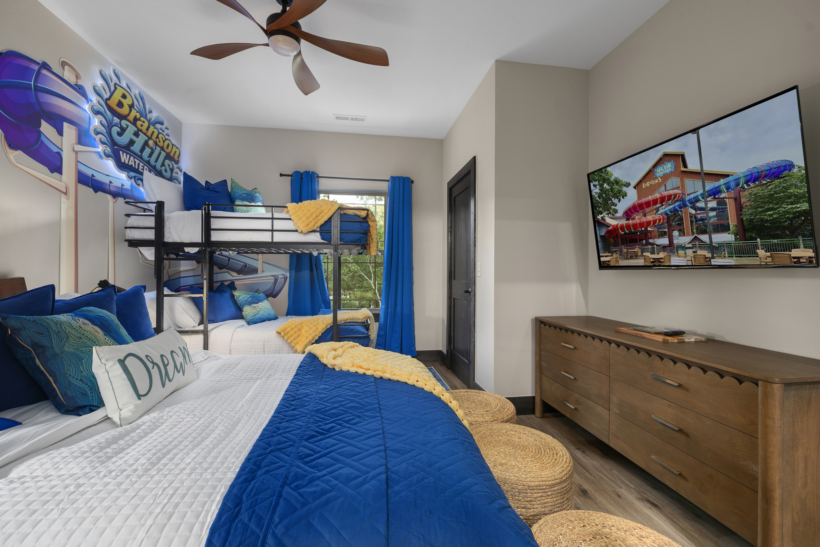 A wall TV and dresser round out the bright, splashy suite.