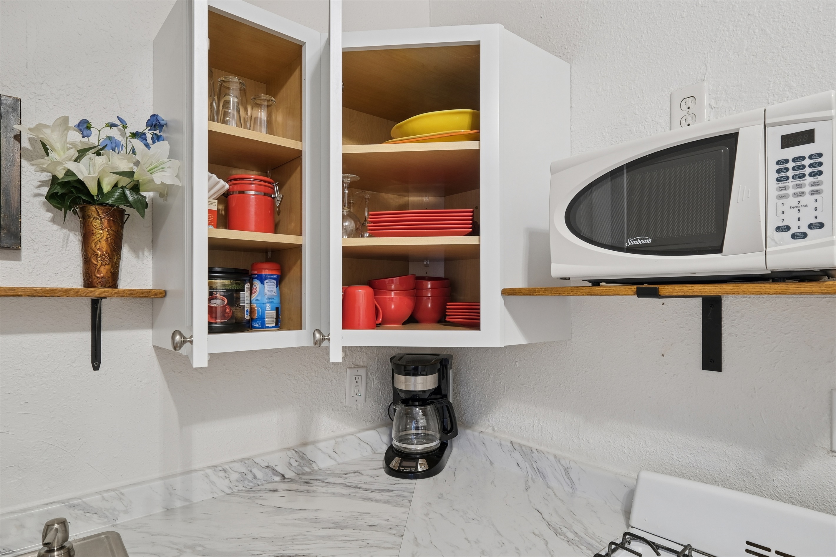 The kitchen is fully stocked with dishware, pots and pans, and everything you might need for a stay. 