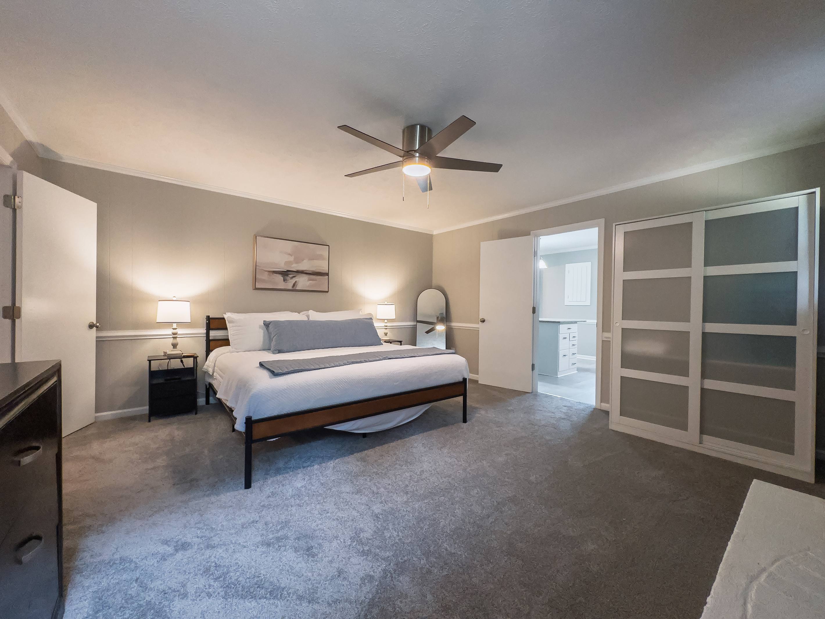 King bed, 55" Smart TV, ceiling fan, two led light nightstands with multiple charging ports, two multi light function lamps, blackout curtains, dresser, wardrobe closet, full length mirror, stylish brick fireplace - not in use.