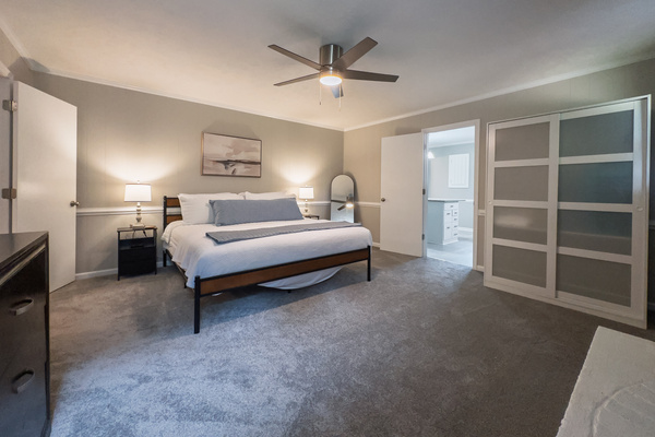 King bed, 55" Smart TV, ceiling fan, two led light nightstands with multiple charging ports, two multi light function lamps, blackout curtains, dresser, wardrobe closet, full length mirror, stylish brick fireplace - not in use.