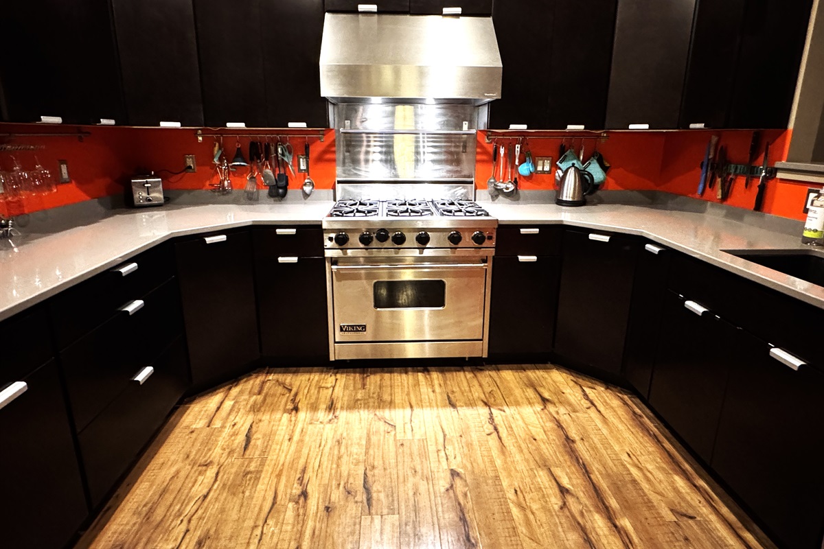 Fully equipped chef's kitchen featuring a professional-grade Viking range and expansive granite countertops. This modern space includes stainless steel appliances and full inventory for easy meal prep, making it a great home base for your group.