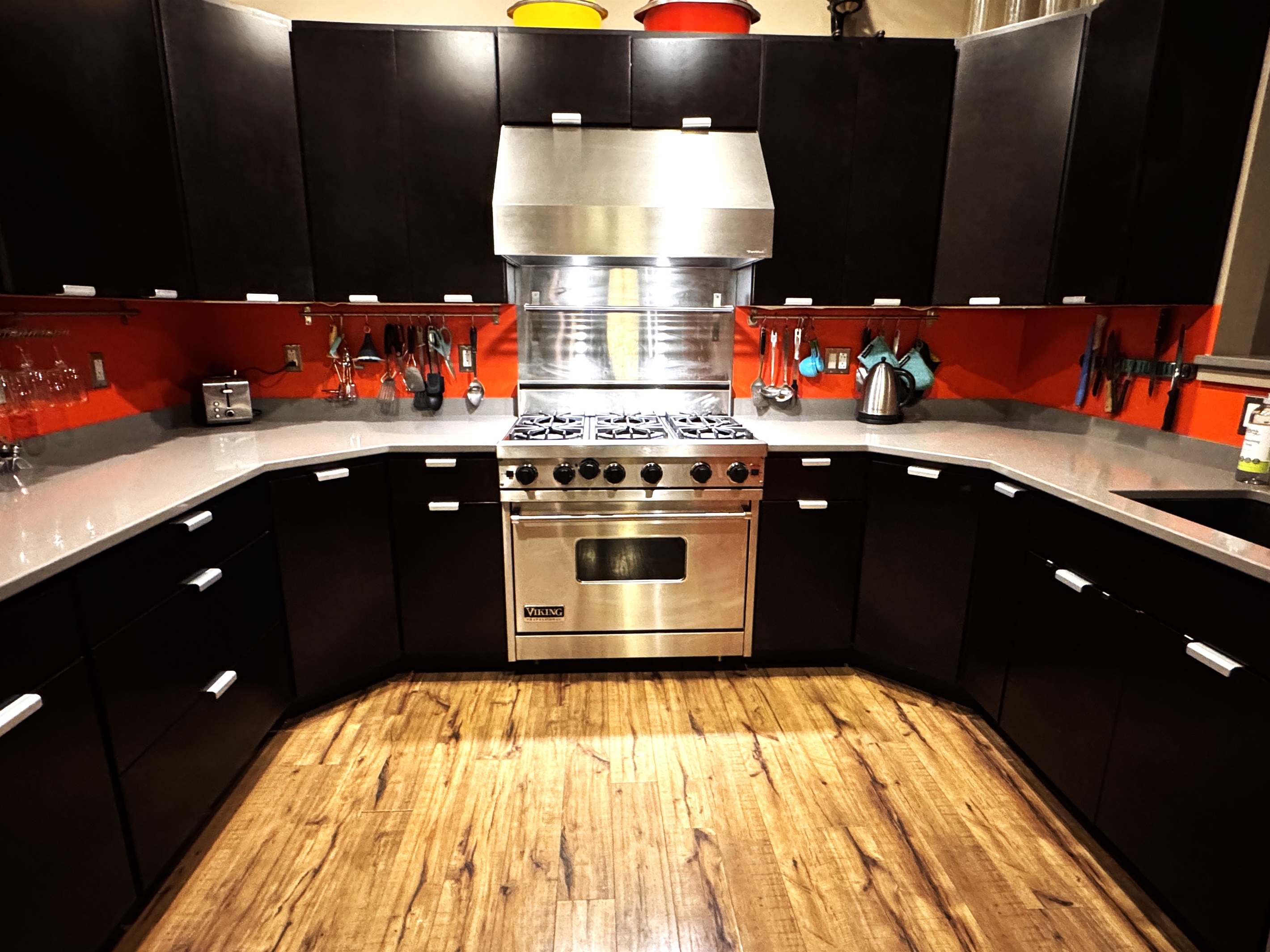 Fully equipped chef's kitchen featuring a professional-grade Viking range and expansive granite countertops. This modern space includes stainless steel appliances and full inventory for easy meal prep, making it a great home base for your group.