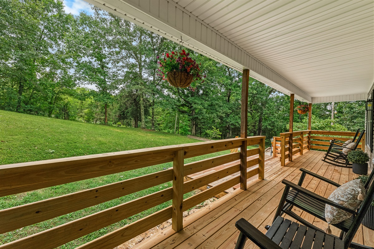 Rock, relax, repeat. This peaceful porch is your front-row seat to nature’s slow show. 🌳🪑✨