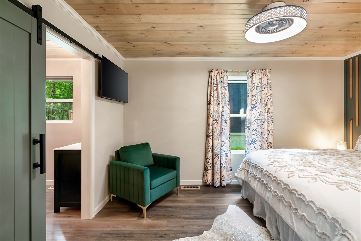 Welcome to your retreat! We love the modern sage barn door leading to the private ensuite bath and the cozy reading nook.