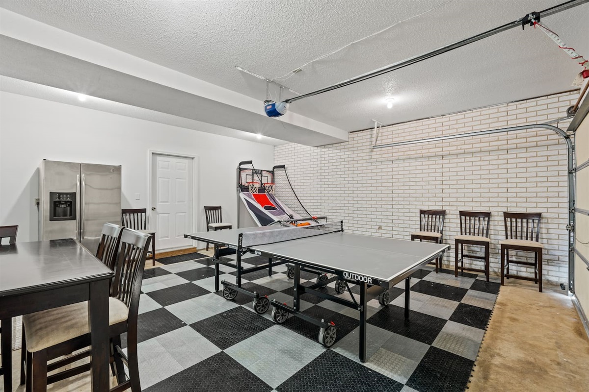 Ping pong, and basketball indoors with and extra refrigerator, and seating to gather around 