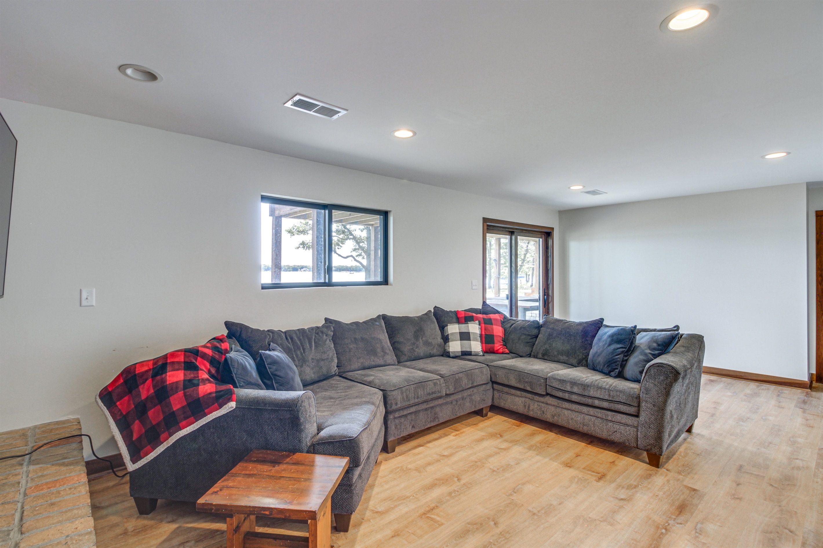 Spacious lower-level lounge area with sectional seating and walk-out access
