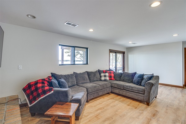 Spacious lower-level lounge area with sectional seating and walk-out access