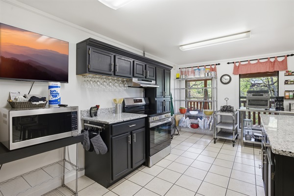 2nd cooking area in Kitchen with Electric stove, Roku TV and Microwave. 