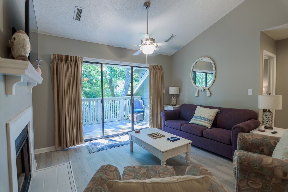 Comfortable living room with large TV and deck access