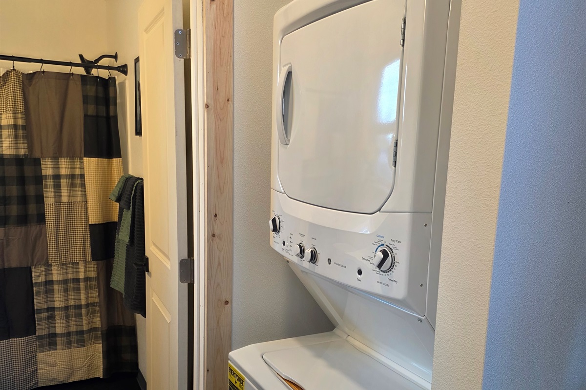 Stacked Washer/Dryer located just outside of the bathroom.