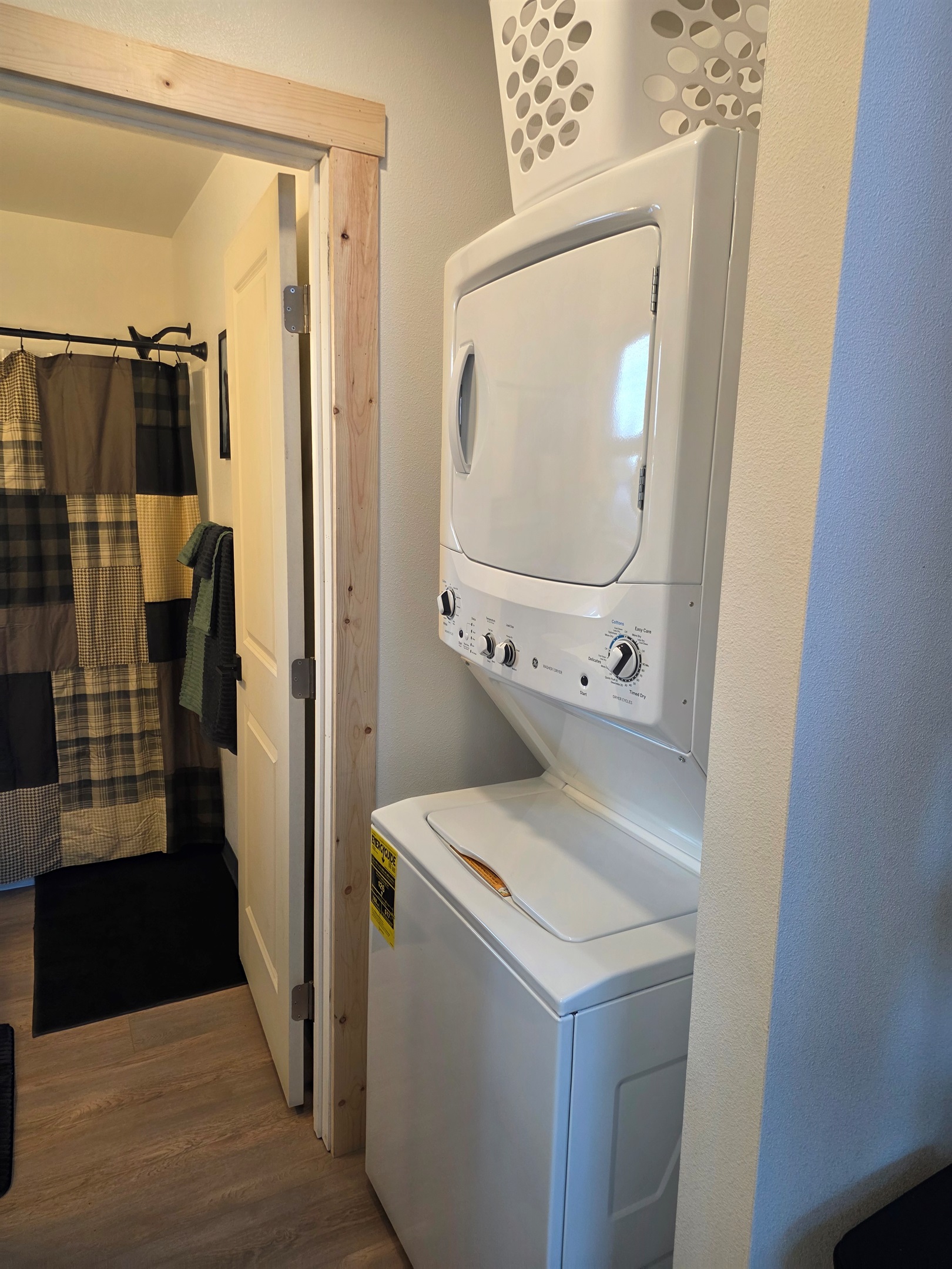 Stacked Washer/Dryer located just outside of the bathroom.