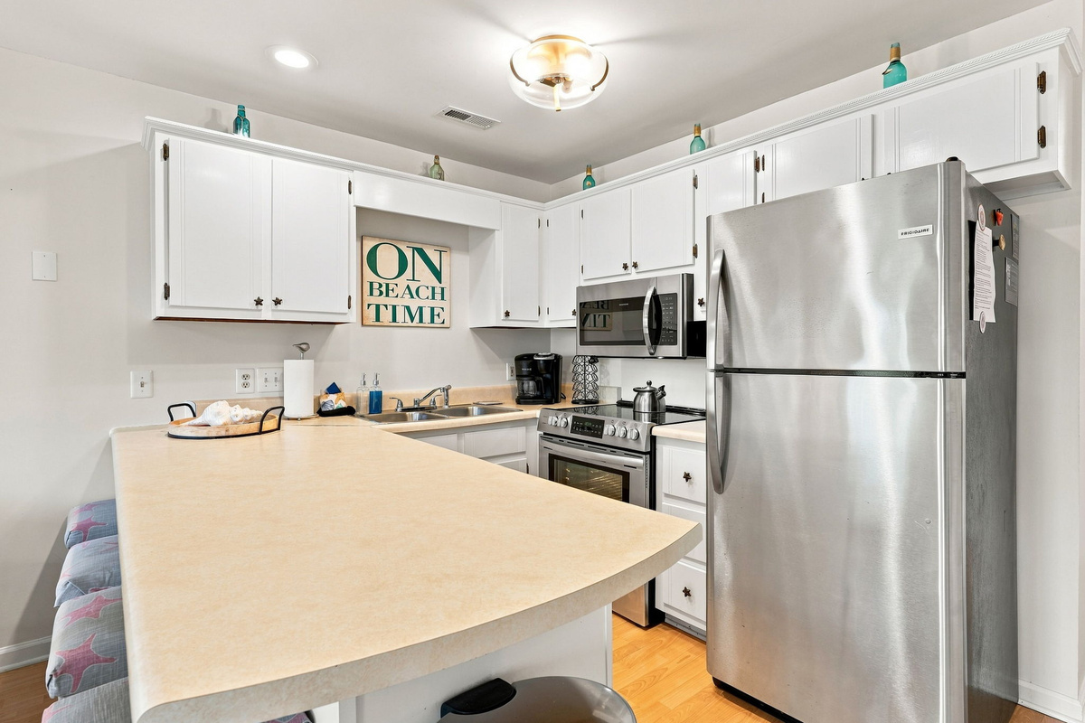 Seamlessly transition from preparing meals to gathering at the breakfast bar just steps away.