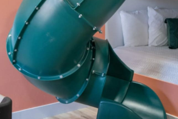 Why take the stairs when there's a slide? This built-in tube turns "time for bed" into the best part of the day, top bunk to floor in three seconds flat.
