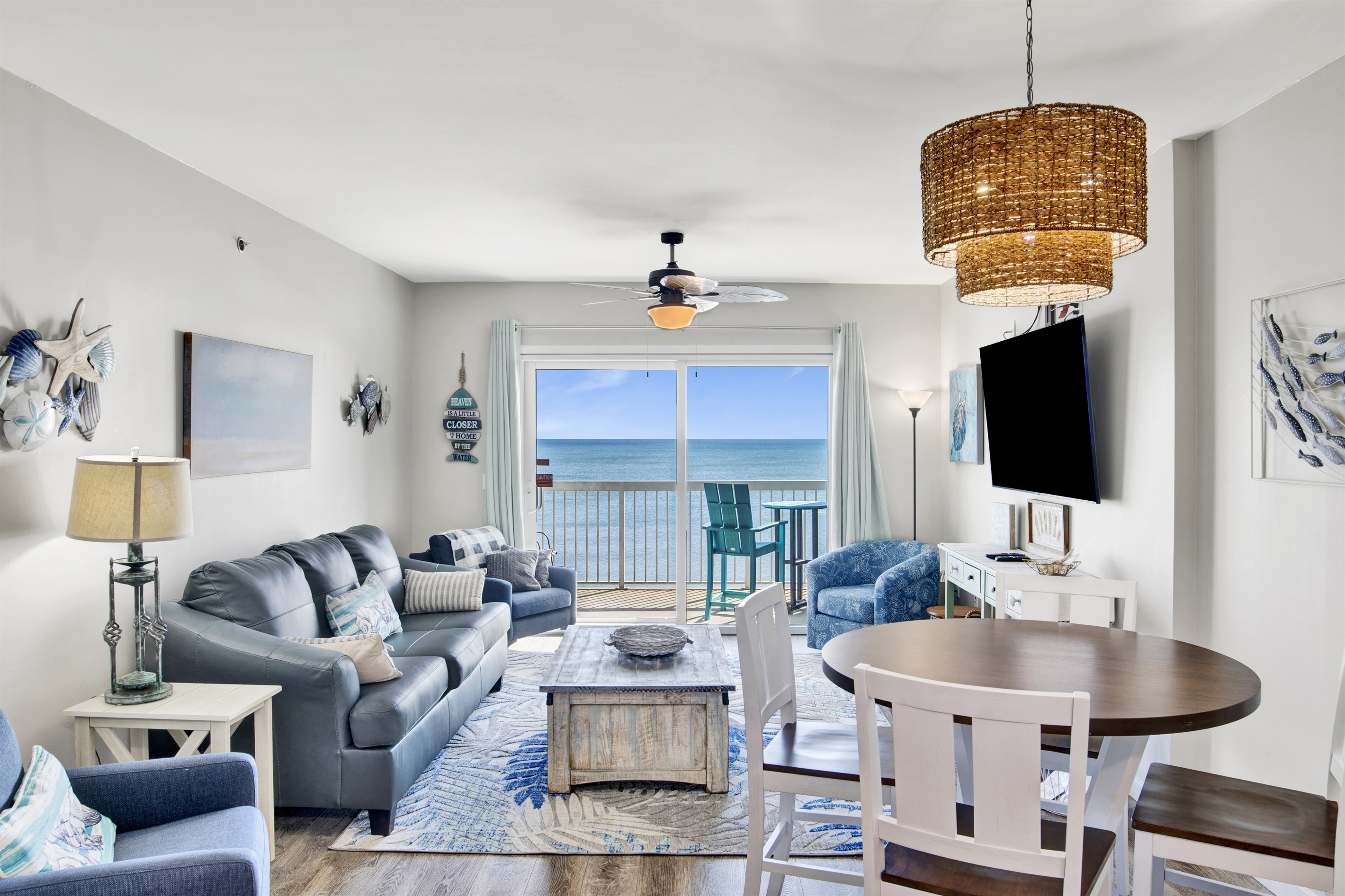 Living room with a leather sleeper sofa, 3 armchairs a wall mounted smart TV and a breathtaking Gulf view!