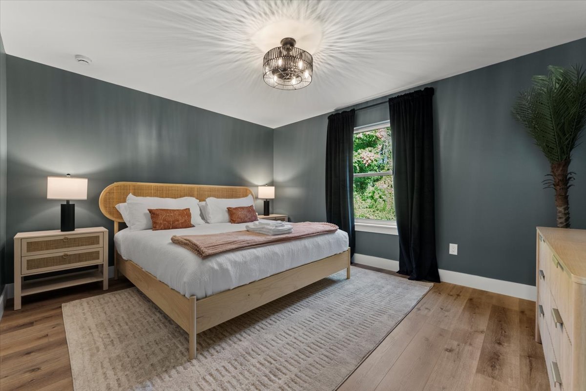 Primary bedroom with a king bed, soft lighting, and calming design elements for a restful night’s sleep.