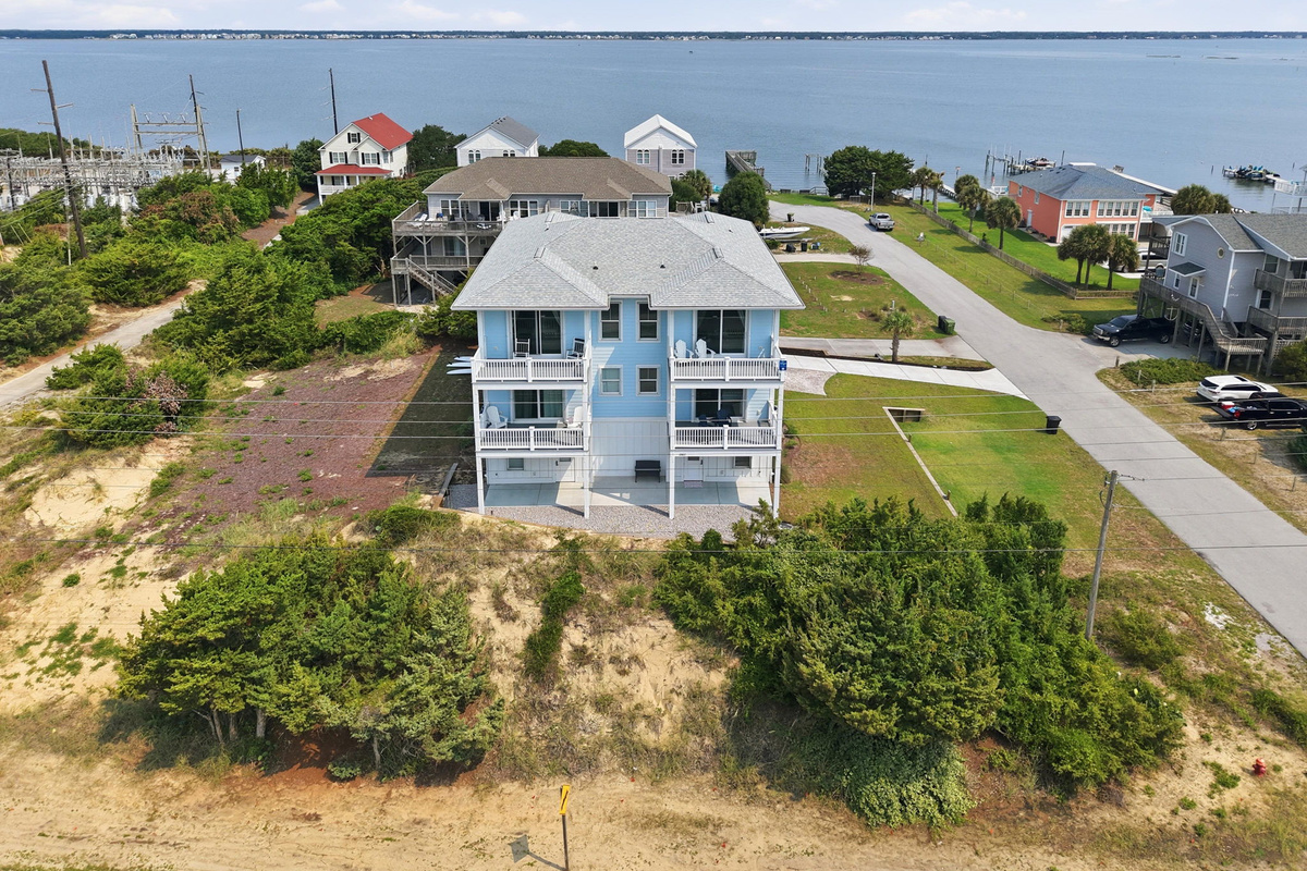 Aerial view showcasing the home&rsquo;s prime location between the sound and ocean, with water views and nearby coastal surroundings