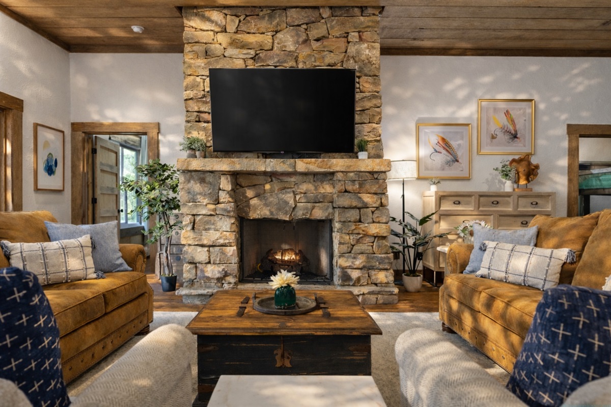 The lower level living room features a cozy stone fireplace, plush seating, and large windows that frame the serene outdoor views.
*Indoor Fireplace (Seasonal Use October - April)