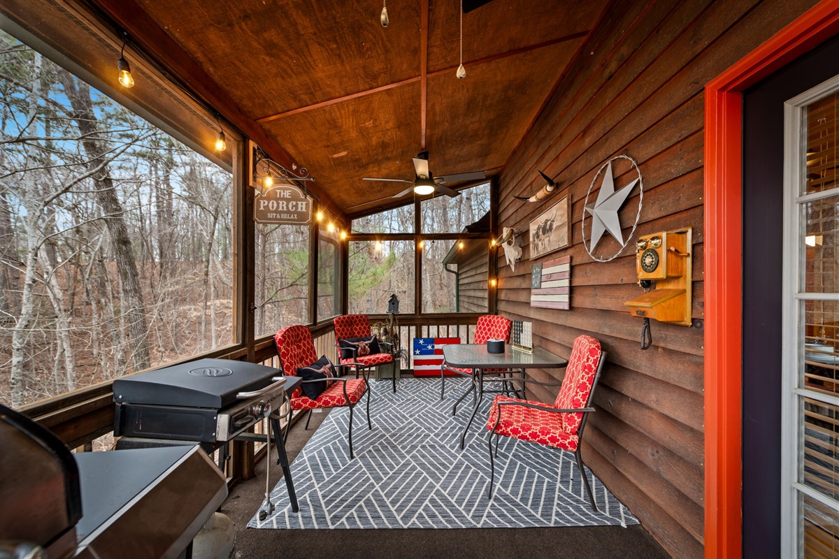 The screened porch offers a comfortable outdoor retreat with cozy seating and beautiful surrounding views.