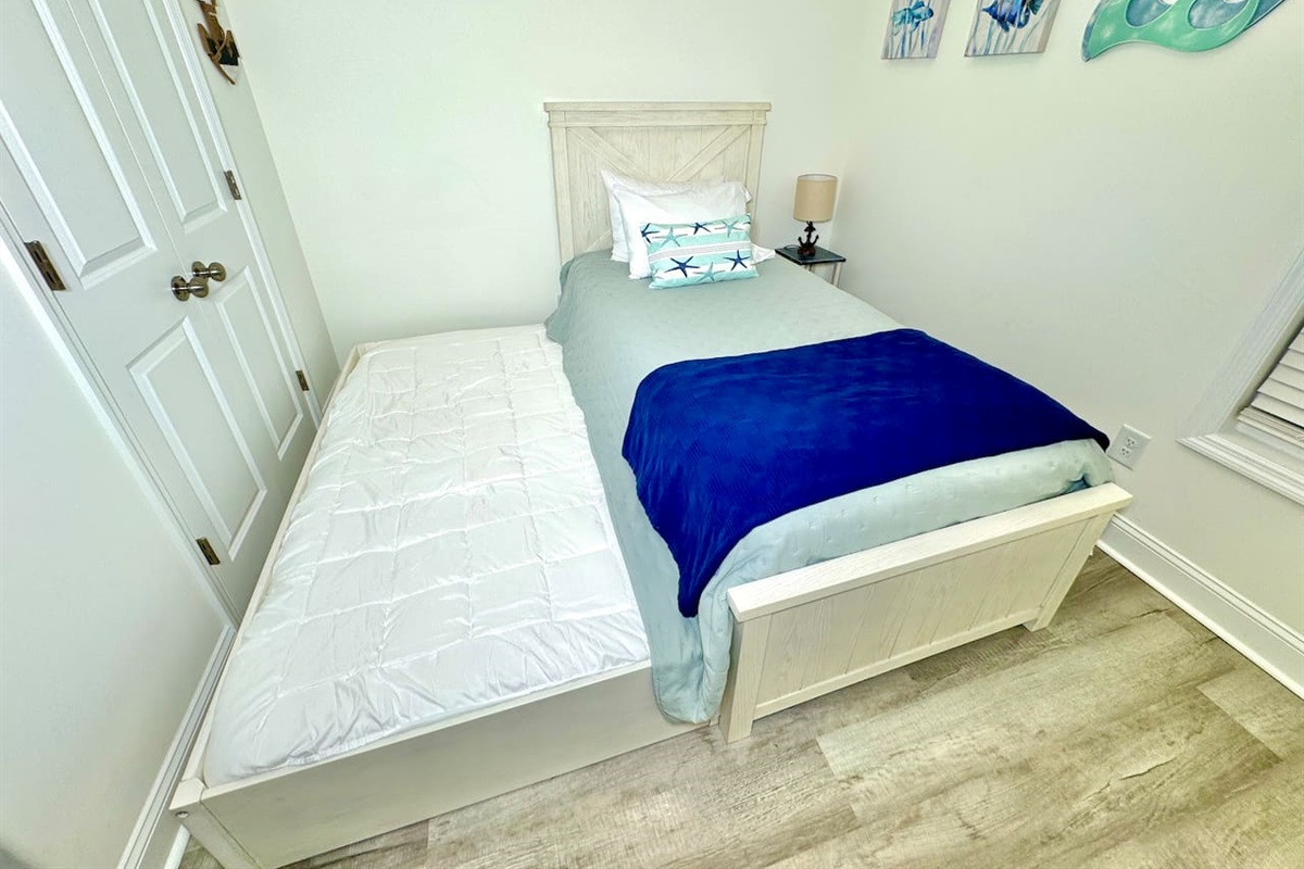 Twin trundle bed with blackout curtains. Linens for bottom twin trundle bed in closet. 