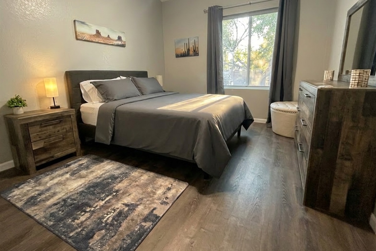 Bedroom #2:Comfortable queen bedroom with soft linens, warm lighting, and modern desert-inspired art. 