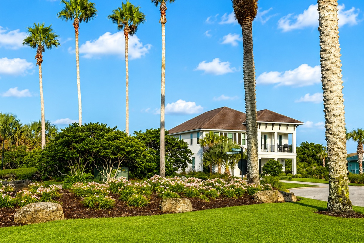 Welcome home for the week. Framed by swaying palms and endless blue Florida sky, this stately coastal retreat is where your family's story unfolds—arrivals full of anticipation, hugs on the porch, and promises to return before you've even left.