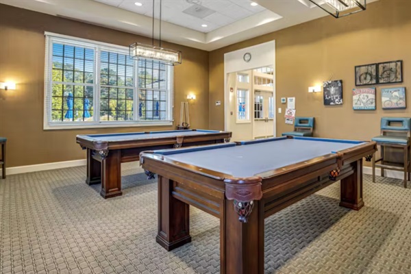 Classic Game Room: Challenge your crew to a friendly match on our full-size pool tables, illuminated by soft, ambient lighting for the ultimate game-night atmosphere.