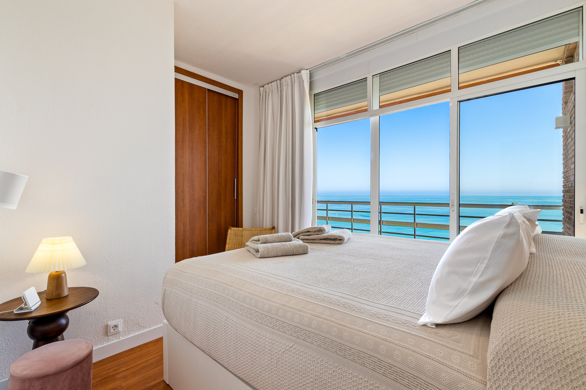 Second bedroom with direct sea views and private balcony access.