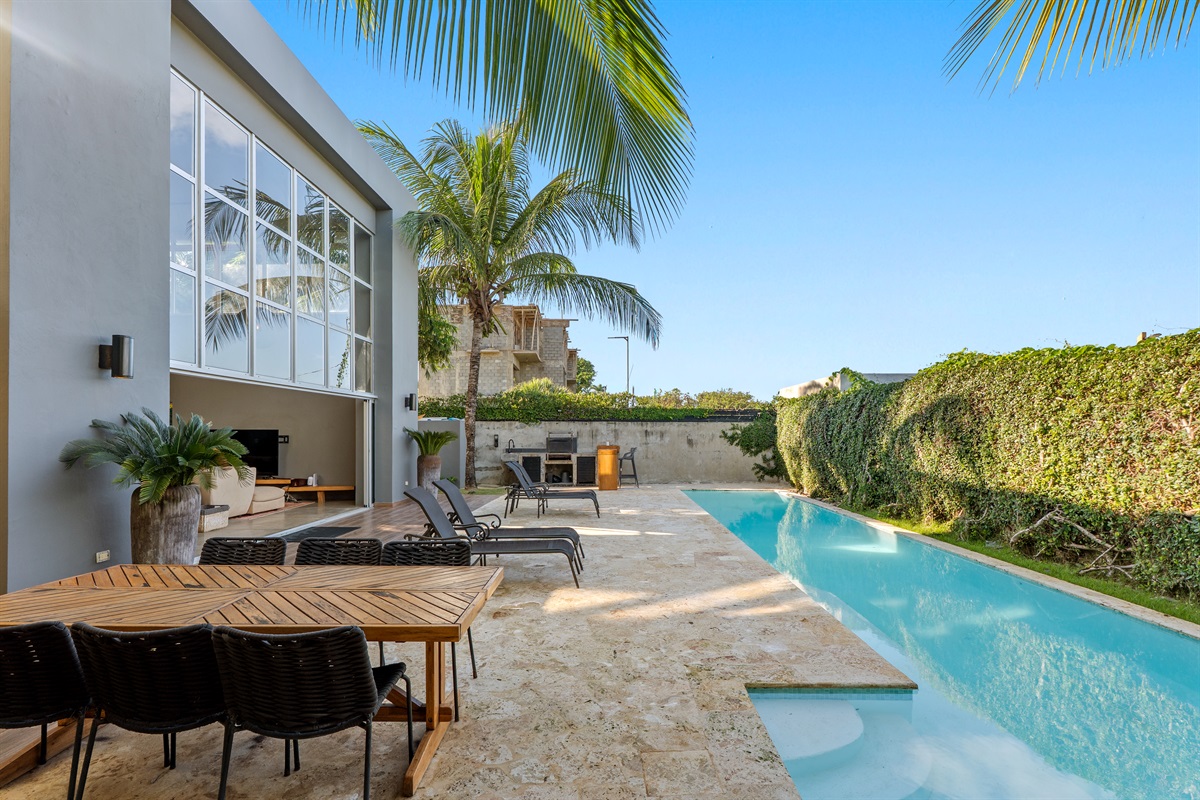 Beautiful pool area surrounded by palm trees.