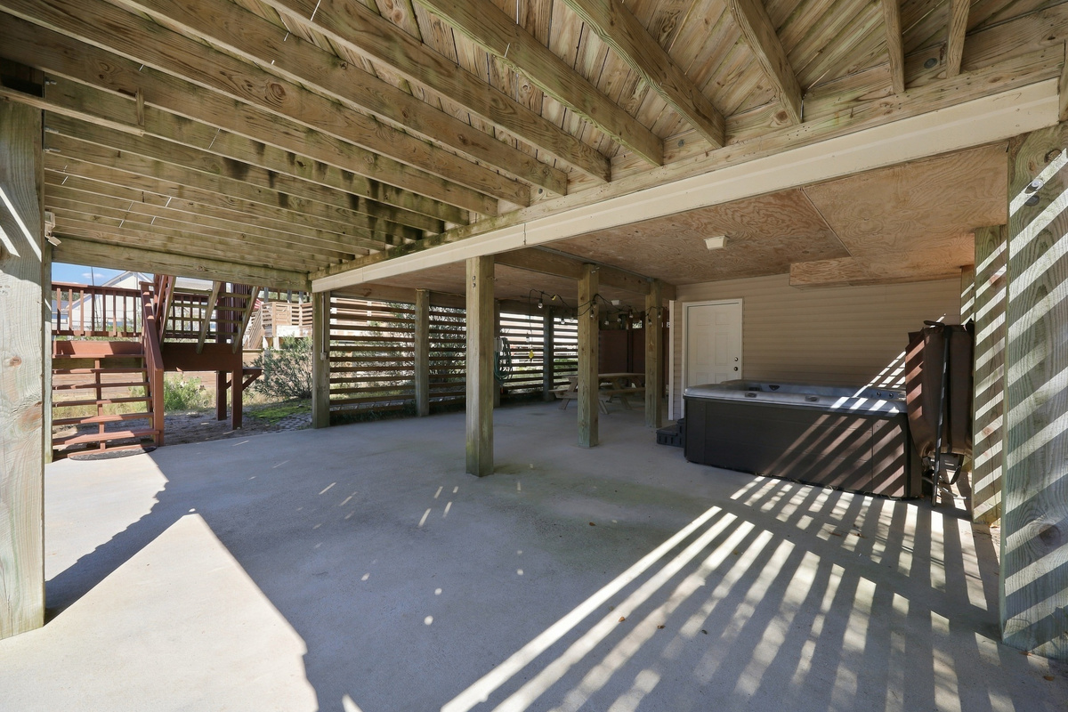 The shaded carport level keeps the car cool and leads to the hot tub and picnic area.