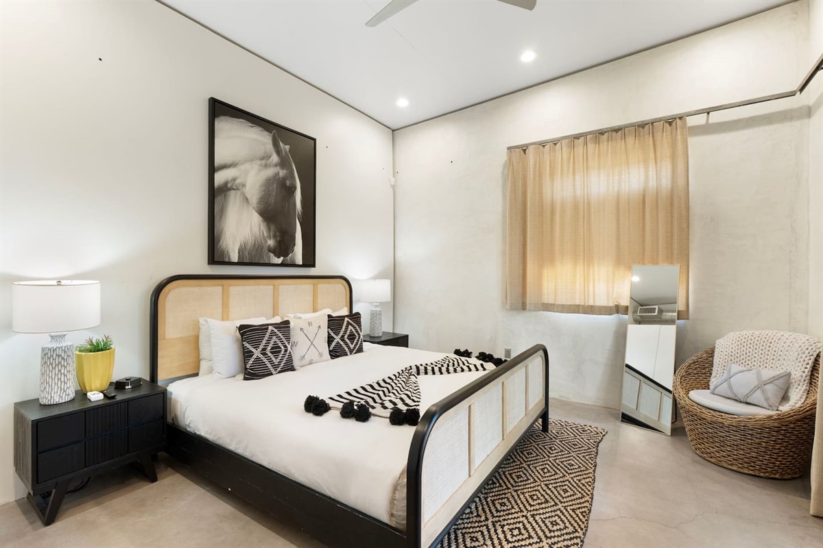 Serene bedroom with a king bed, stylish decor, and soft natural light.