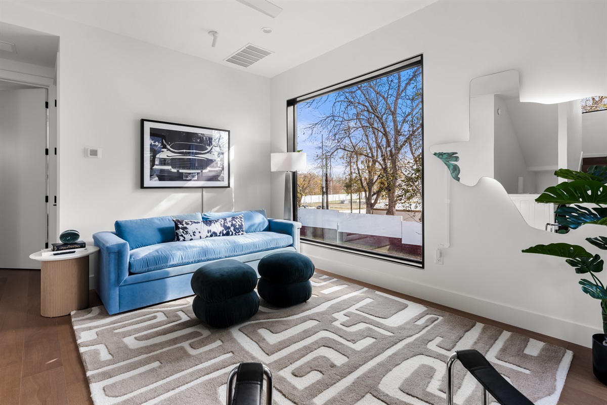 Cozy secondary living room with plush seating and natural light—perfect for quiet conversations, reading, or relaxing away from the main space.