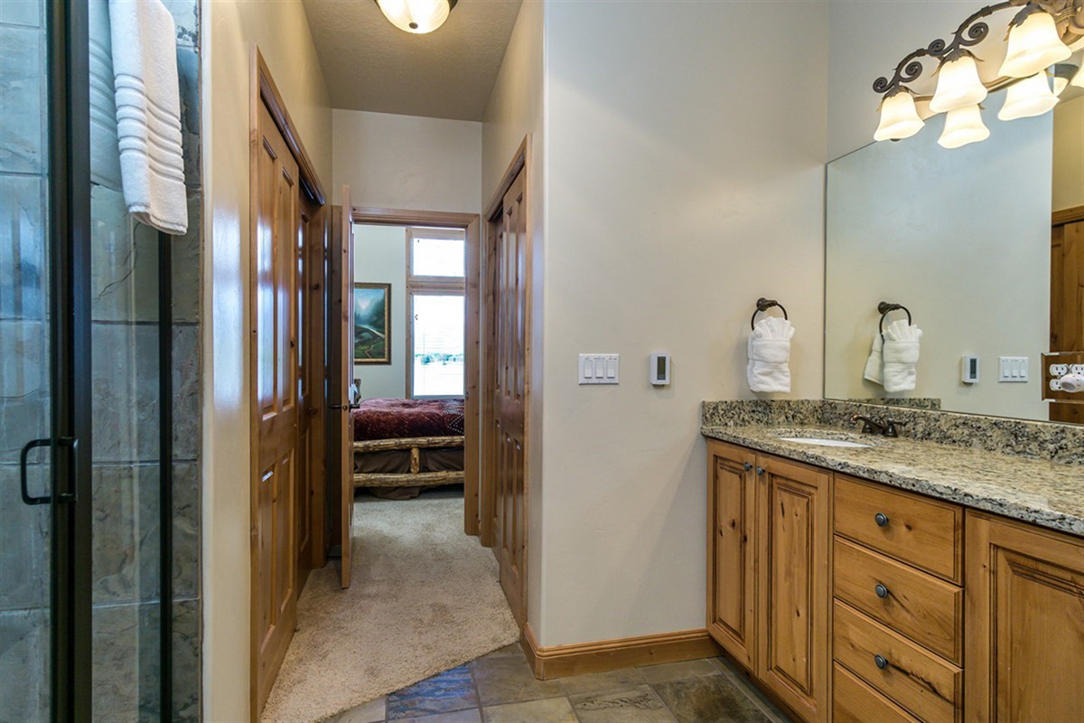 A well-appointed bathroom with granite countertops and quality finishes, offering both style and convenience.