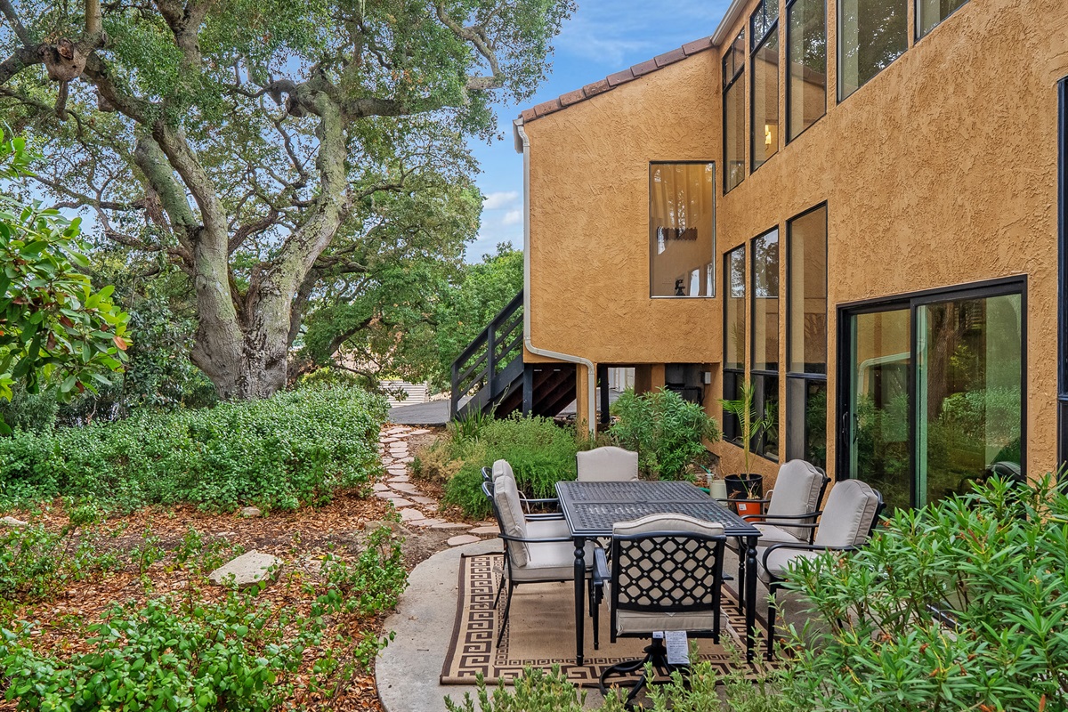 Enjoy meals and cocktails around the six-seater table, surrounded by lush, peaceful landscaping.