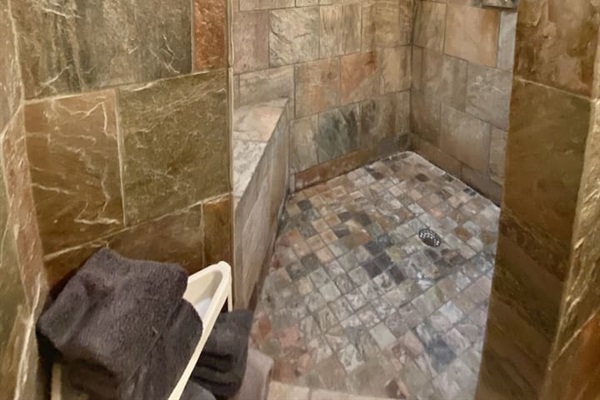 Large walk in shower with rain shower head.