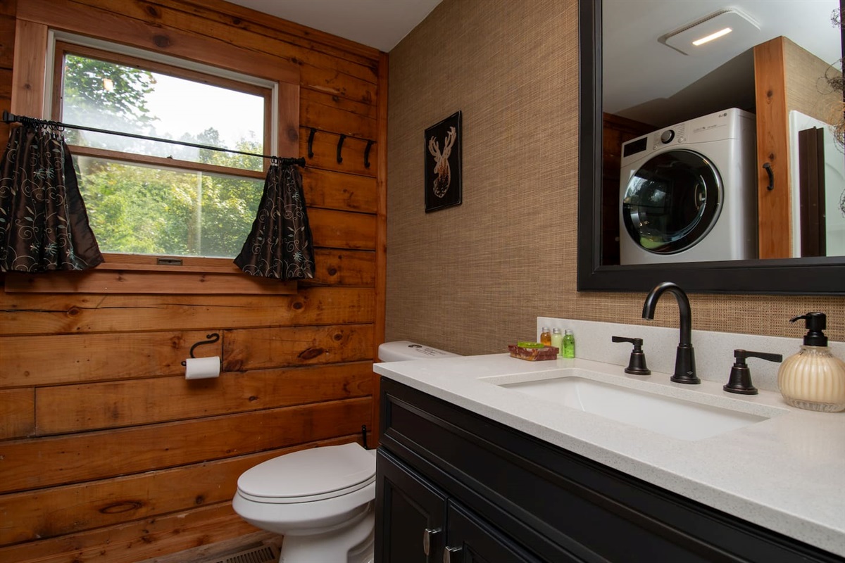 First floor bathroom with shower and laundry. There is enough hand soap for your stay along with 1 ounce starter bottles of shampoo, conditioner and shower gel. You will also be provided with enough toilet paper for your stay.