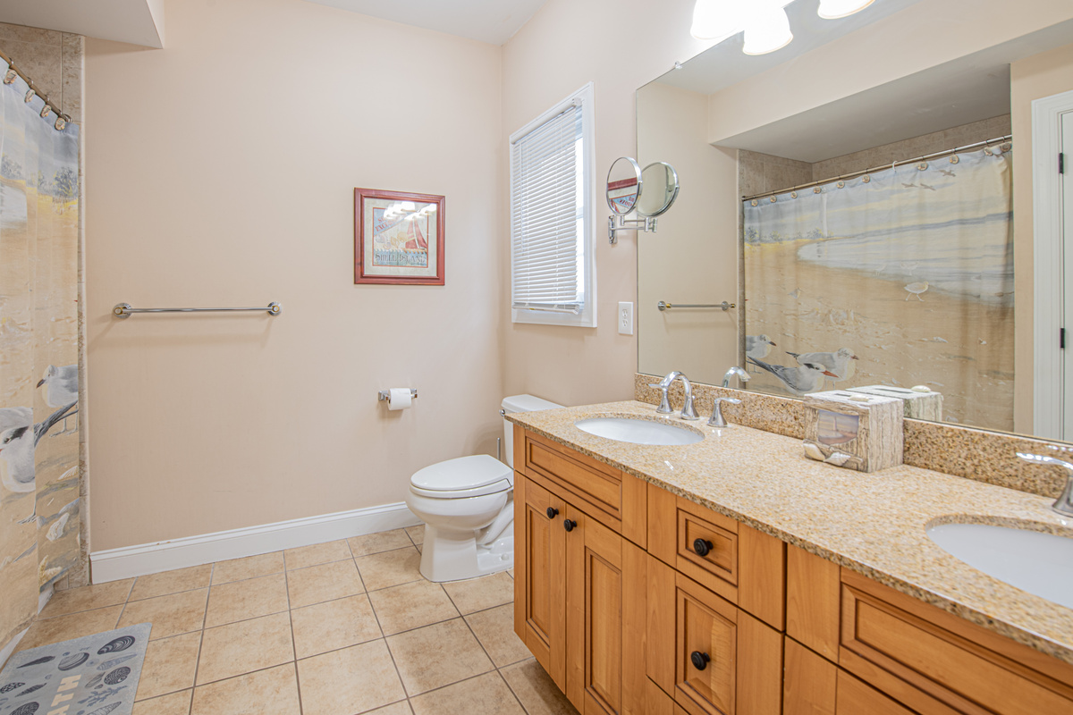 Bathroom 2 with Double Vanity Sink, Large Mirror, and Shower