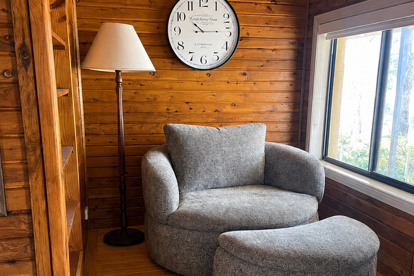 Warm timber walls and a tucked-away chair give this corner of Bob’s River House a cosy retreat feel without leaving the main home.